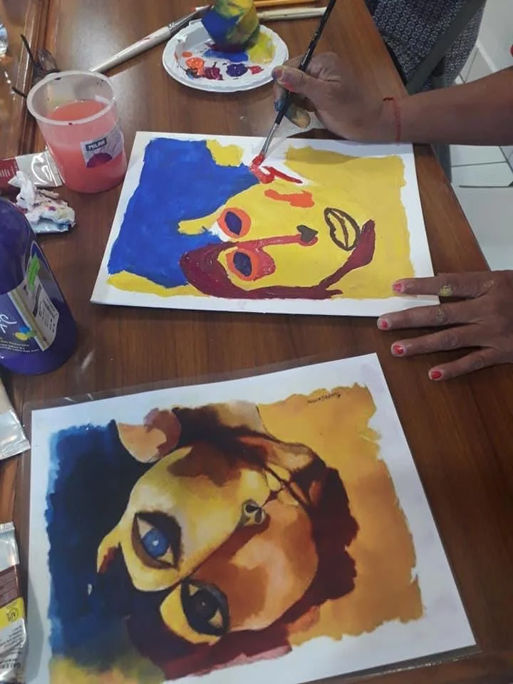 Caregiver and participant sharing a calm creative moment
